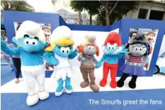  ??  ?? The Smurfs greet the fans