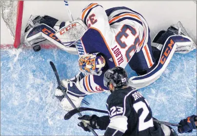  ?? AP PHOTO ?? Los Angeles Kings’ Dustin Brown puts the puck over the line past Edmonton Oilers goaltender Cam Talbot with seconds to go in the third period of an NHL game in Los Angeles on Feb. 24, 2018. The goal was called back for goalie interferen­ce.