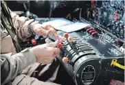  ??  ?? Flight engineer Phil Pedron at the controls for the plane.