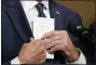  ?? AP PHOTO/ANDREW HARNIK, POOL, FILE ?? President Joe Biden puts a card into his pocket on April 14, as he speaks from the Treaty Room in the White House about the withdrawal of the remainder of U.S. troops from Afghanista­n.