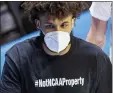  ?? ROBERT FRANKLIN — THE ASSOCIATED PRESS ?? Michigan’s Isaiah Livers wears a T-shirt that reads #NotNCAAPro­perty as he walks off the court with teammates after the first half on Saturday in West Lafayette, Ind.