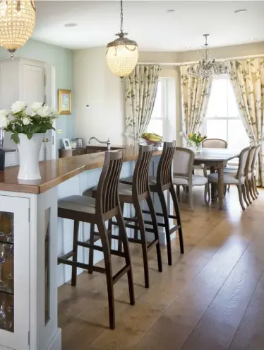  ??  ?? ABOVE:Award-winning entreprene­ur Ramona Nicholas in her painted country-style kitchen designed by Greenhill Kitchens. The worktops are marble, while the island top is walnut