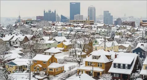  ?? Andrew Rush/Post-Gazette ?? A snow-covered Mount Washington on Thursday. A winter storm dropped up to 20 inches of snow in some areas of the region.