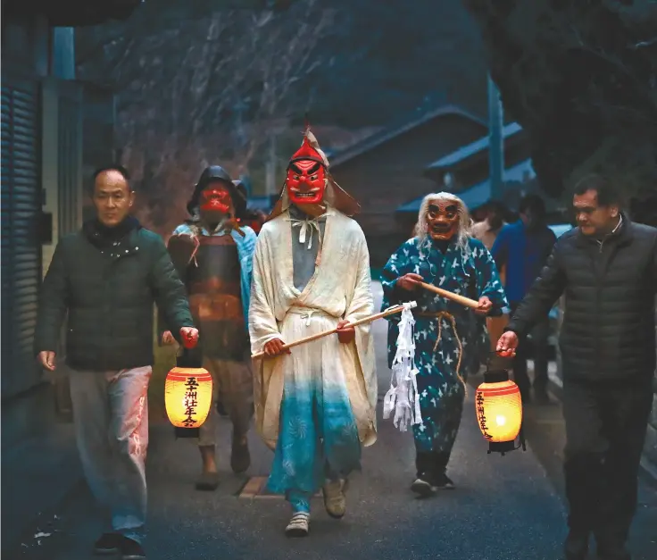  ?? Yomiuri Shimbun photos ?? Main: Amamehagi deities walk home in the Igisu district of Wajima, Ishikawa Prefecture, on Jan. 2. Right: Traditiona­l masks of Namahage deities are seen in the Ashizawa district of Oga, Akita Prefecture, on Dec. 5, 2018.