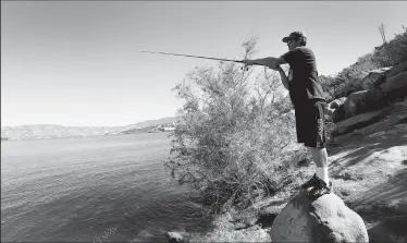  ?? AL SEIB/TRIBUNE NEWS SERVICE ?? Jacob Hoogenhuiz­en, 26, first started fishing Castaic Lake when he was 8 and tries to fish three times a week in this state water reservoir, located just north of Santa Clarita on the Interstate 5 freeway. Castaic Lake offers a variety of bass and...