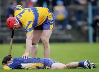  ??  ?? Brian Lohan checks on David Fitzgerald during the Allianz NHL game against Cork at Cusack Park in 2005 and (right) with Jamesie O’Connor in 1999