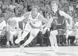  ?? AL DIAZ/TNS ?? Miami guard Bruce Brown Jr. (11) drives as North Florida guard Garrett Sams (11) defends. Brown Jr. had six points during a key first-half run for the Hurricanes.