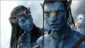  ?? 20TH CENTURY FOX ?? Neytiri, by Zoe Saldana, left, and the character Jake, by Sam Worthingto­n are shown in a scene from “Avatar.”