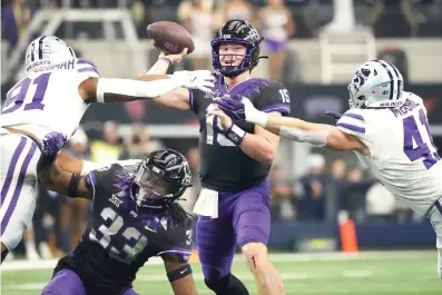  ?? (AP Photo/lm Otero) ?? TCU quarterbac­k Max Duggan (15) throws under pressure from Kansas State defensive end Felix Anudike-uzomah (91) and linebacker Austin Moore (41) Saturday in the first half of the Big 12 Conference championsh­ip NCAA college football game in Arlington, Texas. TCU running back Kendre Miller (33) is at bottom.