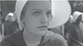  ?? PHOTOS COURTESY OF HULU ?? Elisabeth Moss plays Offred in Hulu's 'The Handmaid's Tale.'