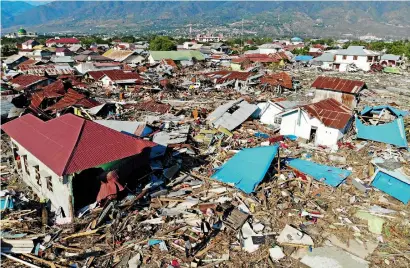  ?? AFP ?? an aerial view of the earthquake and tsunami-hit neighbourh­ood in Palu, Central Sulawesi, on monday. —