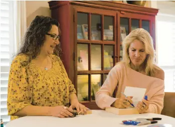  ?? SOPHIE PARK/THE NEW YORK TIMES ?? Elin Hilderbran­d, right, signs a book for Jessica Jackson on Jan. 7 at the Nantucket Hotel in Massachuse­tts. The ninth Bucket List Weekend was recently held on the island where most of the author’s books are set.