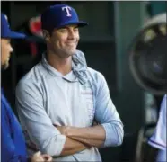  ?? ASHLEY LANDIS — THE DALLAS MORNING NEWS VIA AP ?? Pitcher Cole Hamels smiles as he talks to his Rangers teammates in the dugout on Thursday in Arlington, Texas.