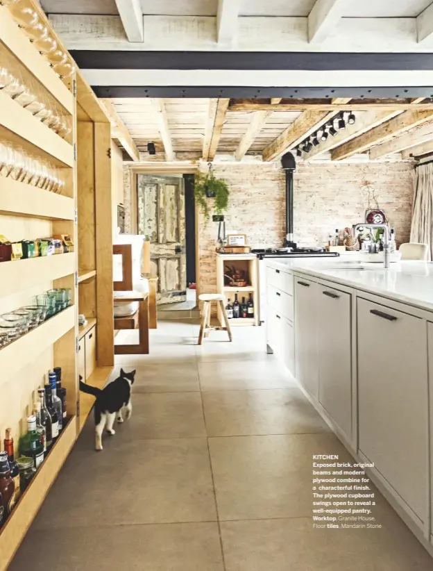  ??  ?? KITCHEN
Exposed brick, original beams and modern plywood combine for a characterf­ul finish. The plywood cupboard swings open to reveal a well-equipped pantry. Worktop, Granite House.
Floor tiles, Mandarin Stone