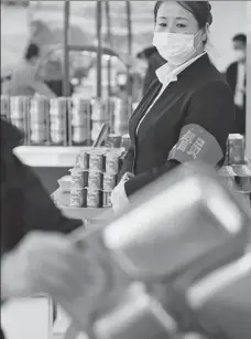  ??  ?? Right: A staff member supervises food waste at a canteen in a gov