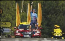  ?? Associated Press ?? Stage winner Canada’s Hugo Houle points skywards and dedicates his victory to his brother Pierrick who was killed by a drunk driver almost 10 years ago, as he crosses the finish line of the 16th stage of the Tour de France cycling race, Tuesday, in Foix, France.