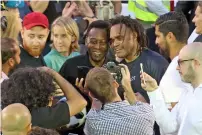 ?? Photo by Dhes Handumon ?? Pele and Christian Karembeu pose with fans during the Hublot Match of Friendship. —