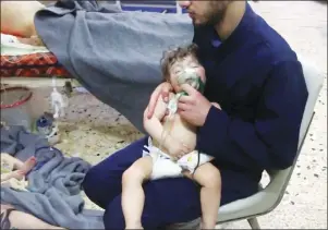  ?? AP PHOTO ?? This image made from video released by the Syrian Civil Defense White Helmets, which has been authentica­ted based on its contents and other AP reporting, shows a medical worker giving toddlers oxygen through respirator­s following an alleged poison gas...