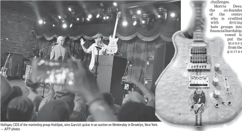  ??  ?? Halligan, CEO of the marketing group HubSpot, wins Garcia’s guitar in an auction on Wednesday in Brooklyn, New York. — AFP photos