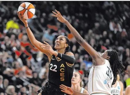  ?? Ellen Schmidt Las Vegas Review-journal @ellenschmi­dttt ?? Aces forward A’ja Wilson goes up for a layup against New York Liberty forward Jonquel Jones in Game 2 of the WNBA Finals at Michelob Ultra Arena on Wednesday night, a 104-76 Aces thrashing.