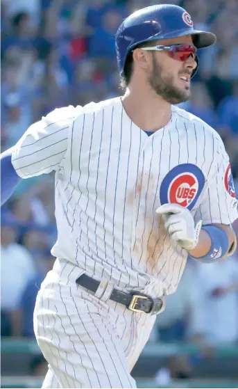  ?? (Photo by Charles Rex Arbogast, AP) ?? Chicago Cubs’ Kris Bryant watches his two-run home run off Pittsburgh Pirates relief pitcher Antonio Bastardo during the eighth inning of Friday’s game.