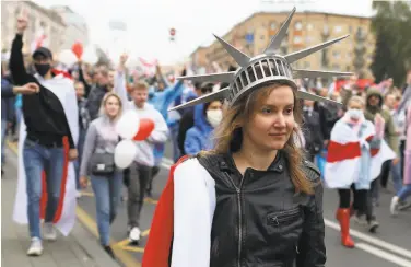  ?? TUT.by ?? A protester wears a Statue of Liberty crown Sunday during a mass march in the capital of Minsk.