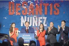  ?? PHELAN M. EBENHACK/ASSOCIATED PRESS ?? Florida Gov.-elect Ron DeSantis, second from left, thanks supporters at an election party Tuesday in Orlando, Fla., after being declared the winner of the Florida gubernator­ial race.