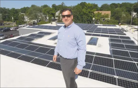  ?? Erik Trautmann / Hearst Connecticu­t Media ?? Greg Miller, of the Paul Miller Nissan dealership in Fairfield, tours his family dealership, which has installed a solar- energy array with financing from Darien- based Greenworks Lending.