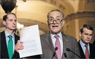  ?? NICHOLAS KAMM/GETTY-AFP ?? Senate Minority Leader Chuck Schumer, D-N.Y., shows a letter written to GOP leaders.