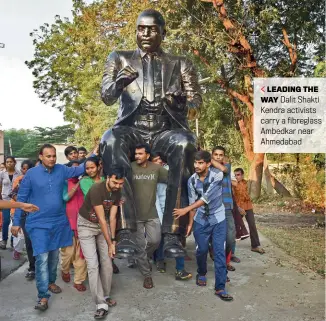  ??  ?? LEADING THE WAY Dalit Shakti Kendra activists carry a fibreglass Ambedkar near Ahmedabad