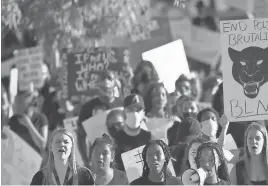  ?? ROSS D. FRANKLIN/AP ?? Protesters march during a rally at Cesar Chavez Park on June 3, in Laveen, Ariz., protesting the death of George Floyd, who died May 25 after being restrained by Minneapoli­s police.