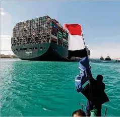  ?? SUEZ CANAL AUTHORITY VIA AP ?? Observers celebrate the freeing Monday of the 220,000-ton cargo ship Ever Given, which had been stuck in the Suez Canal for days, halting traffic in one of the world’s most vital maritime arteries.