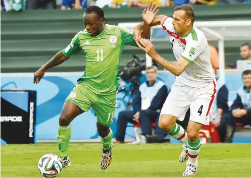  ??  ?? Nigeria's forward Victor Moses challenges Iran's defender Jalal Hosseini during the Group F match at the 2014 FIFA World Cup in Brazil