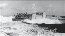  ?? THE ASSOCIATED PRESS ?? In this in June 1944 filr photo, United States landing craft loaded with troops and equipment churn through heavy seas bound for the beaches of Saipan, Mariana Islands.