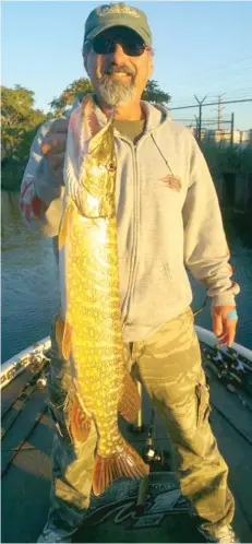  ?? | JEFF BAFFA/ FOR THE SUN- TIMES ?? Ricardo Placenti caught his first northern pike while fishing for bass and chasing muskie Sunday on the Calumet.