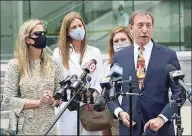  ?? H. John Voorhees III / Hearst Connecticu­t Media ?? Defense attorney Jon Schoenhorn, representi­ng Michelle Troconis, center, addresses the media outside the Stamford courthouse on Aug. 28.