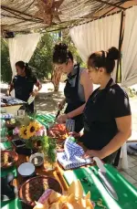  ??  ?? Sarah Jesson, centre, learns how to make salsa from Azalia Nelson, right. Cooking classes at Flora’s Field Kitchen are a way to learn about Mexican culture.