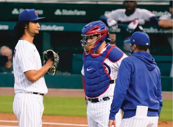  ?? NUCCIO DINUZZO/GETTY IMAGES ?? Cubs pitching coach Tommy Hottovy visits the mound to talk with Yu Darvish after he loaded the bases in the first inning Sunday at Wrigley Field.
