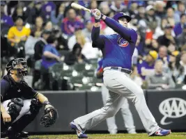  ?? Morry Gash ?? The Associated Press Anthony Rizzo follows through on a go-ahead home run in front of Brewers catcher Erik Kratz leading off the 11th inning of the Cubs’ 7-2 victory Monday at Miller Park.
