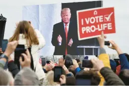  ?? OLIVIER DOULIERY/GETTY-AFP ?? Pro-life demonstrat­ors listen to then-President Donald Trump at the 2020 March for Life in Washington. On Monday, he issued an abortion policy video.