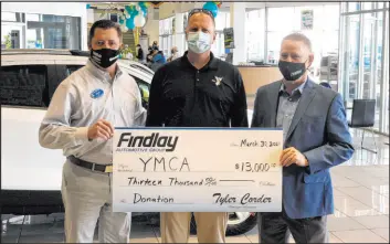  ?? Findlay ?? Doug Fleming, left, general manager of Findlay Chevrolet, and Tyler Corder, right, CFO Findlay Automotive, award a check for $13,000 to Mike Lubbe of the YMCA.