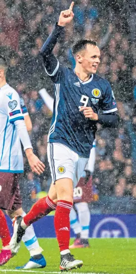  ??  ?? Lawrence Shankland celebrates scoring for Scotland.