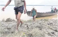 ??  ?? Farmers make their way onto Hintha Kyun island in the Salween River near Mawlamyine.