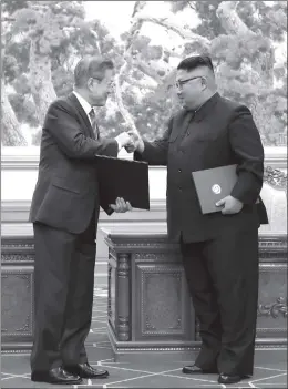  ?? Photo: AFP ?? North Korean leader Kim Jong-un and South Korean President Moon Jae-in exchange documents during a signing ceremony after their summit on Wednesday. Kim agreed to close a missile testing site in front of internatio­nal inspectors as a rare interKorea­n summit unfolded in Pyongyang, and would soon make a historic visit to Seoul.