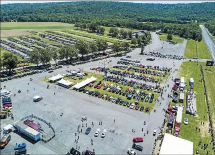  ?? PHOTO COURTESY OF TURN5 ?? More than 2,000 Mustangs lined the fields of Maple Grove Raceway in Berks County at Turn5’s 10th Anniversar­y AmericanMu­scle Mustang Show in June, with Mustangs traveling from Ontario, Canada to as far south as the Florida panhandle. The event raised $117,000 for the Make-A-Wish Foundation.