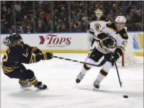  ?? GARY WIEPERT — THE ASSOCIATED PRESS ?? Right winger Brian Gionta (12), pictured here during his time with the Buffalo Sabres in 2016, reaches out to try to stop a clearing pass during a game against the Boston Bruins. Gionta will serve as captain of the U.S. Olympic hockey team at the...