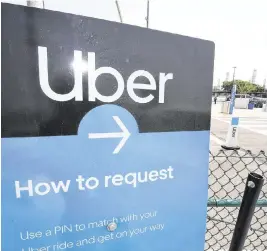  ?? ROBYN BECK AFP/Getty Images/TNS ?? To improve safety, Uber says it has started a pilot program with verificati­on badges. Miami is one of the cities in the program.