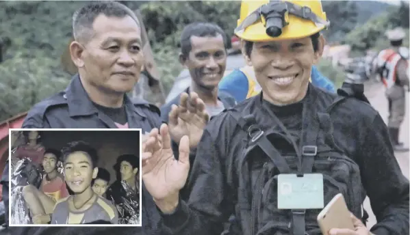  ?? MAIN PICTURE: GETTY IMAGES ?? 0 Rescue workers show their relief after the first two boys were brought out of the Tham Luang Nang Non cave complex yesterday