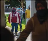  ?? GINA FERAZZI/LOS ANGELES TIMES ?? Potato farmworker­s wait in line outside a small office at Our Redeemer Lutheran Church to receive a $1,000 check to help cover expenses on Oct. 15 in Livingston.