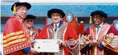  ??  ?? Mahdzir (left) receives an honorary doctorate in education from MAHSA University chancellor Tun Zaki Azmi (middle) while Dr Ismail looks on.